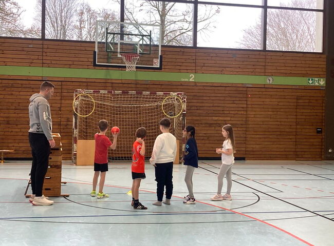 Ein Junge zielt mit einem Ball auf den Basketballkorb